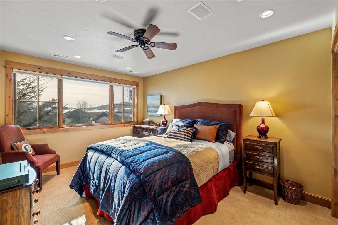 3258 Snowflake Circle, Unit 2 Steamboat Springs, CO 80487 - Photo 25 of 45 a bedroom with a bed and a large window
