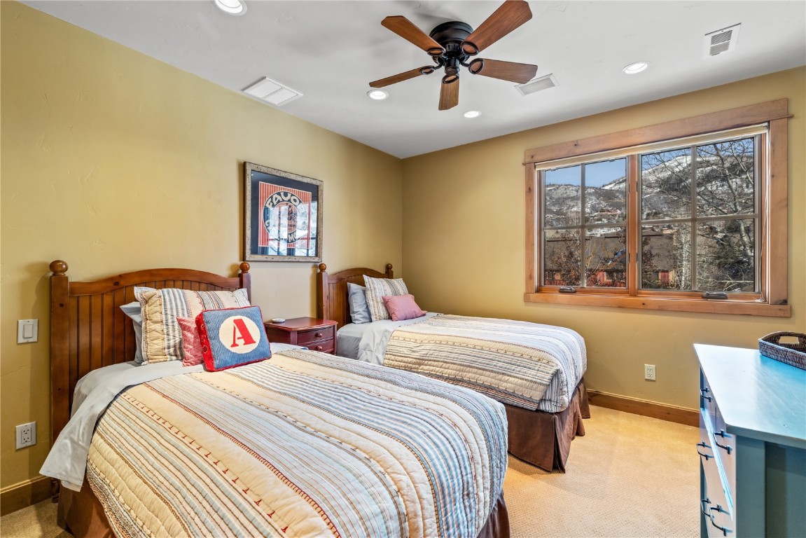 3258 Snowflake Circle, Unit 2 Steamboat Springs, CO 80487 - Photo 28 of 45 a bedroom with a large bed and a large window