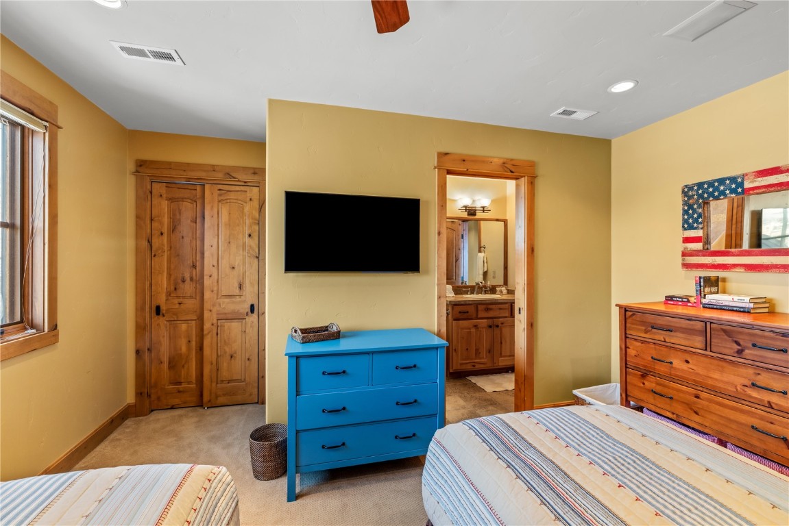 3258 Snowflake Circle, Unit 2 Steamboat Springs, CO 80487 - Photo 29 of 45 a bedroom with a bed and wooden floor