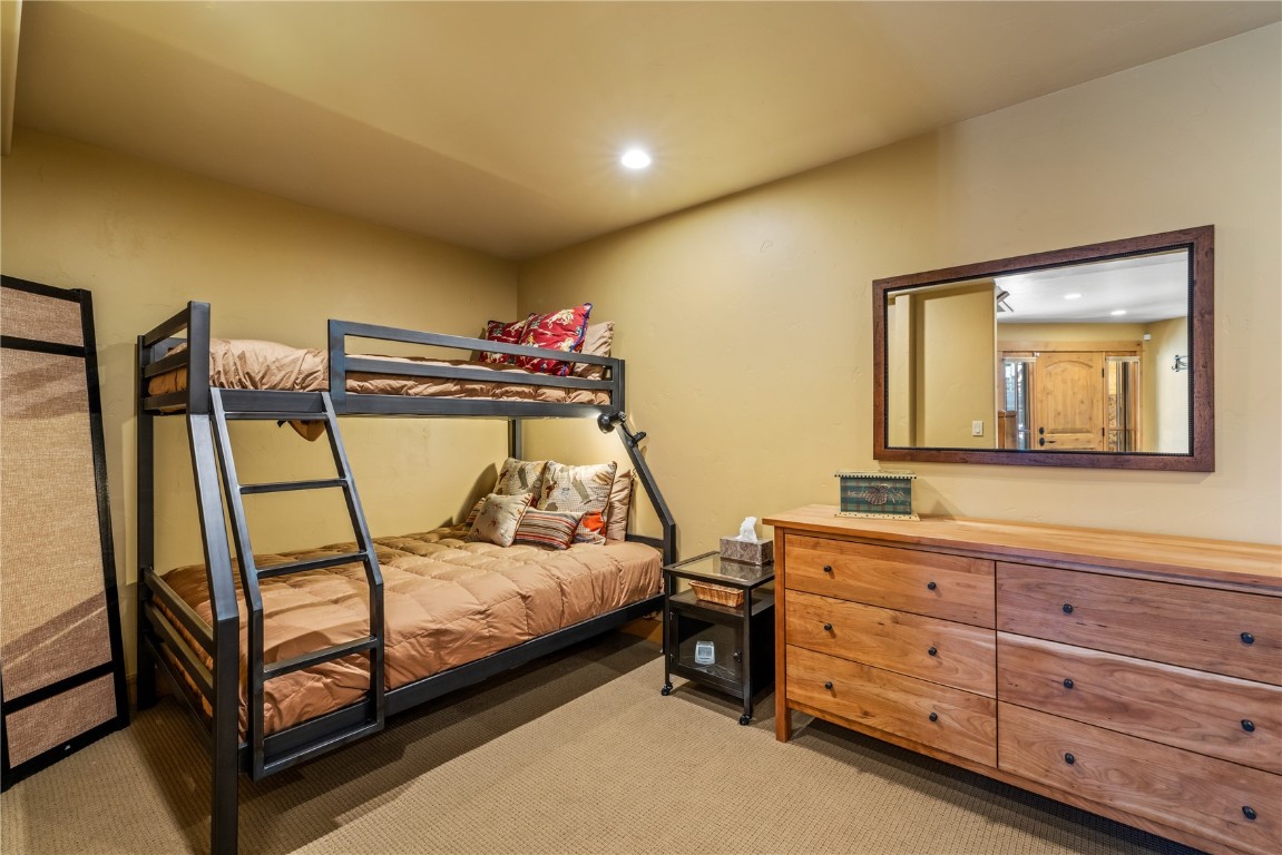 3258 Snowflake Circle, Unit 2 Steamboat Springs, CO 80487 - Photo 38 of 45 a bedroom with a bed and a dresser in it