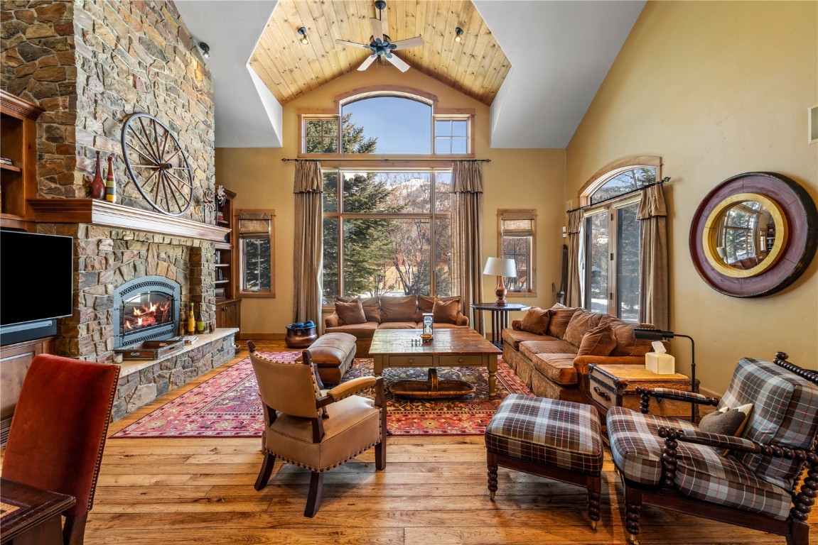 3258 Snowflake Circle, Unit 2 Steamboat Springs, CO 80487 - Photo 5 of 45 a living room with fireplace furniture and a large window