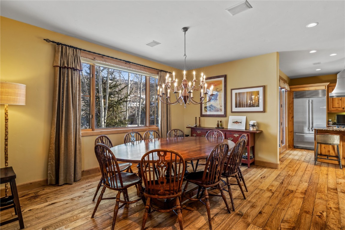 3258 Snowflake Circle, Unit 2 Steamboat Springs, CO 80487 - Photo 8 of 45 a view of a dining room with furniture window and wooden floor