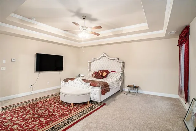 a living room with a bed and a flat screen tv