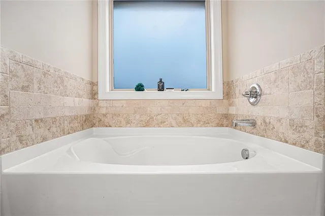 a view of walk in closet with clothes