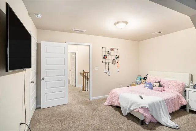 a bedroom with a bed and a large window