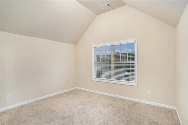 an empty room with an empty space and a bathroom