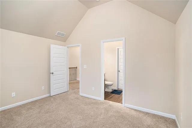 a bathroom with a granite countertop toilet sink and mirror