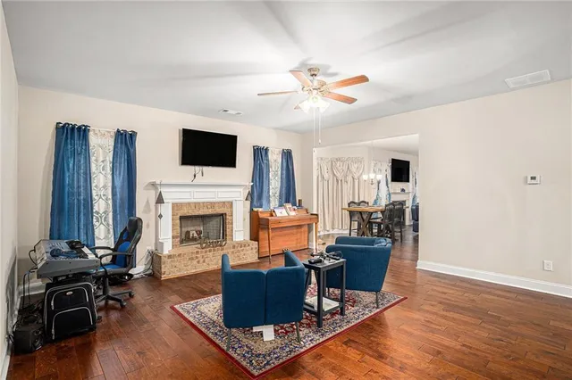 a living room with furniture a fireplace and a flat screen tv