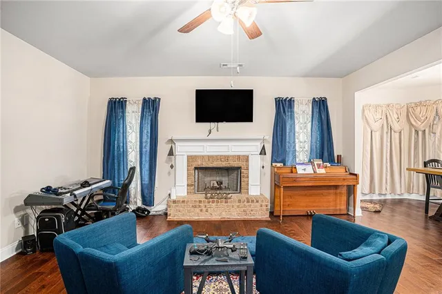 a living room with furniture a flat screen tv and a fireplace