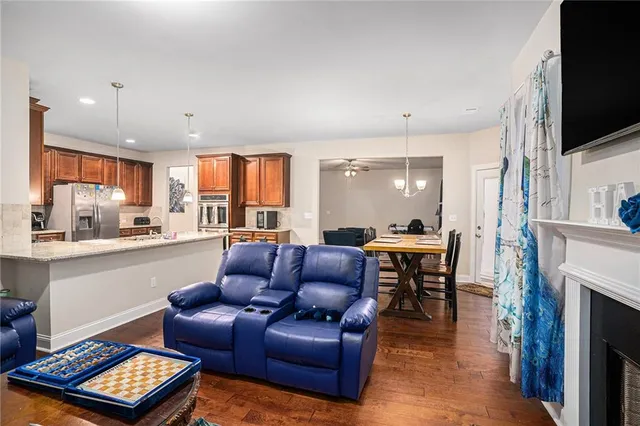 a living room with furniture a fireplace and a flat screen tv