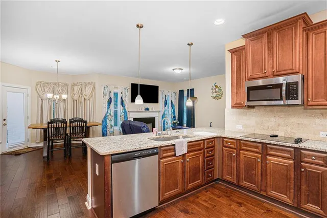 a kitchen with a sink stove and microwave