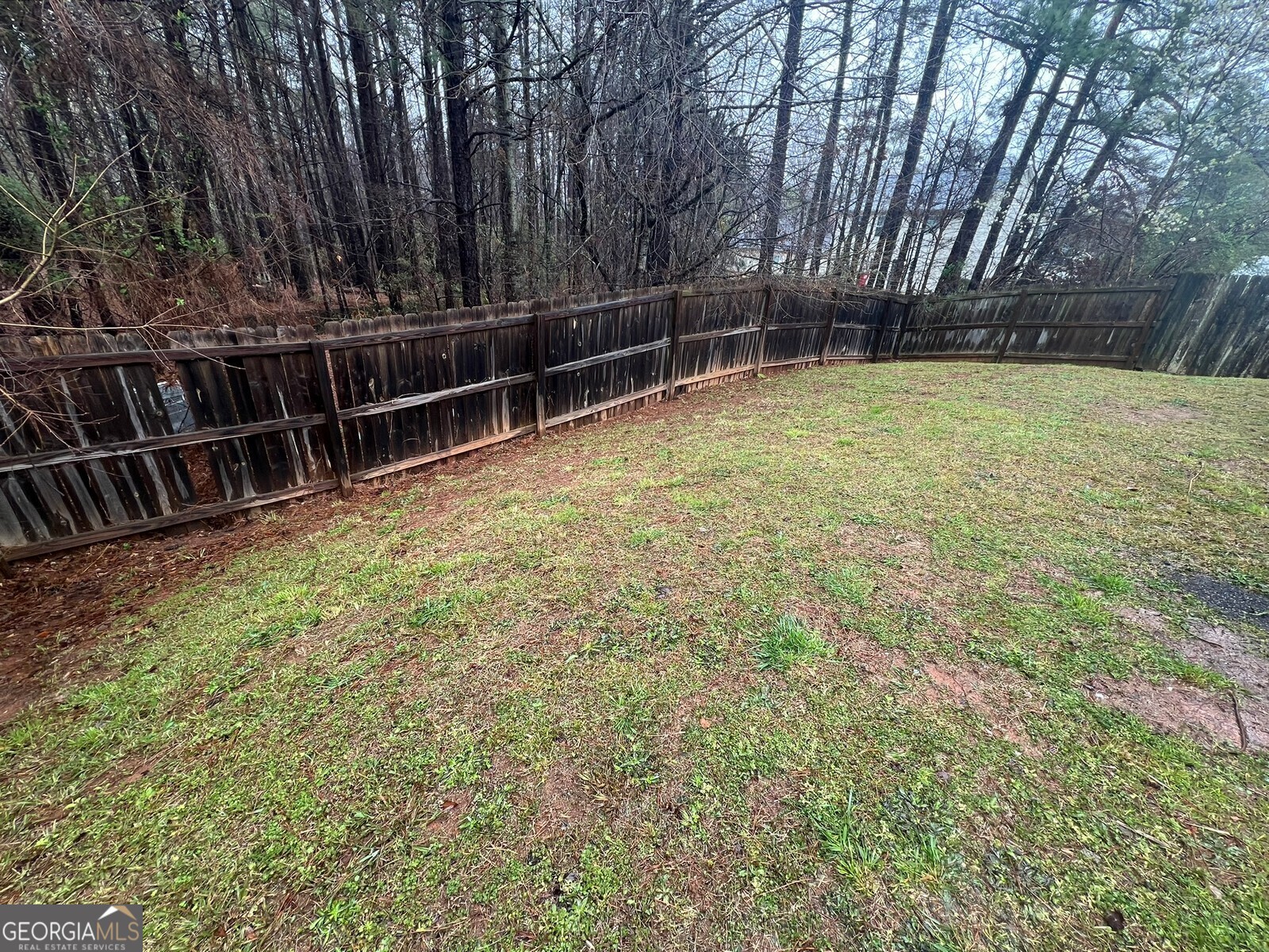 165 Lakeside Point Covington, GA 30016 - Photo 19 of 26 a view of a backyard with a wooden fence