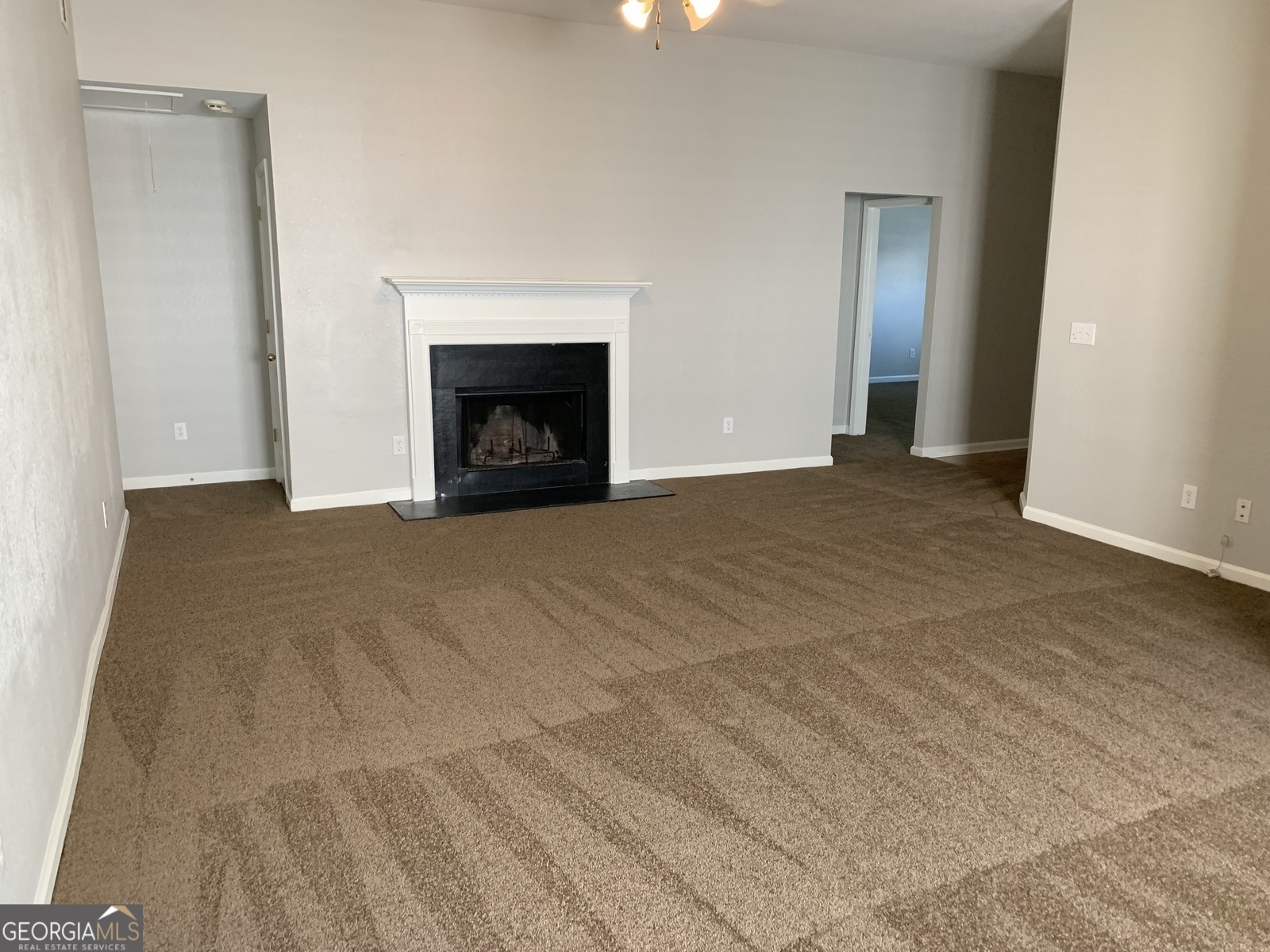 165 Lakeside Point Covington, GA 30016 - Photo 2 of 26 a view of empty room with a fireplace