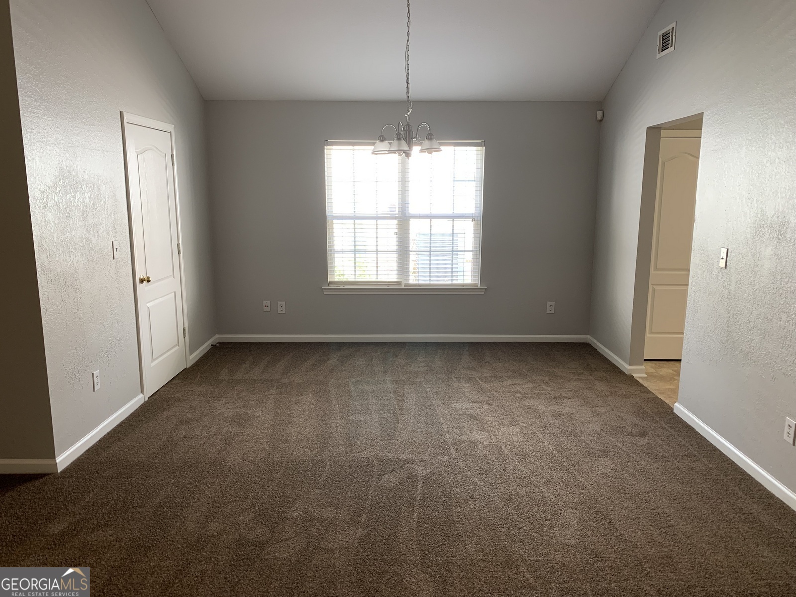 165 Lakeside Point Covington, GA 30016 - Photo 5 of 26 en empty room with windows and entrance