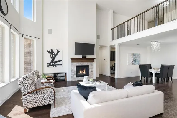 a living room with furniture a fireplace and a flat screen tv