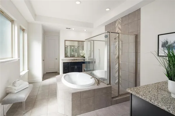 a bathroom with a granite countertop sink a toilet a mirror and shower