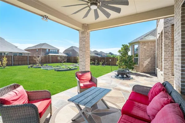 a view of a patio with couches chairs and a big yard
