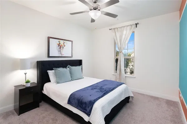 a bedroom with bed and window