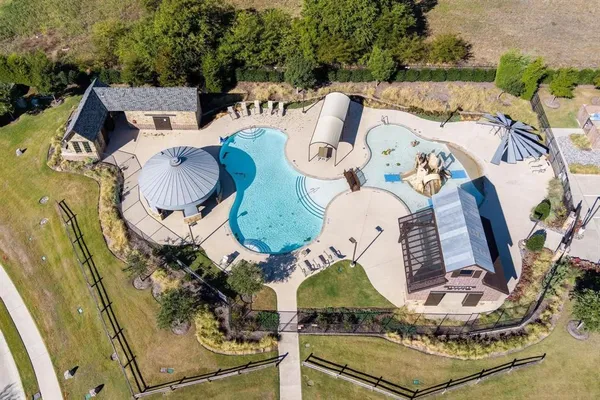 an aerial view of a house with outdoor space and sitting area