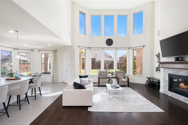 a living room with fireplace furniture and a large window