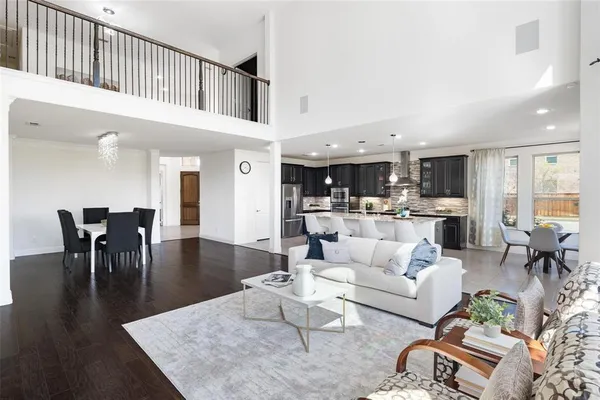 a living room with furniture kitchen view and a dining table