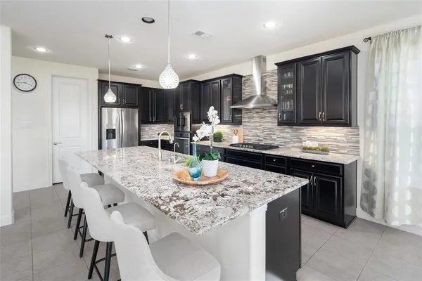 a kitchen with kitchen island granite countertop a table and chairs in it