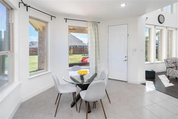 a view of a dining room with furniture and a window
