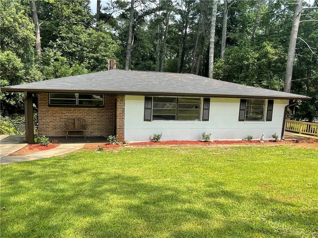 1738 Highland Place Decatur, GA 30035 - Photo 1 of 1 a front view of a house with a yard and garage