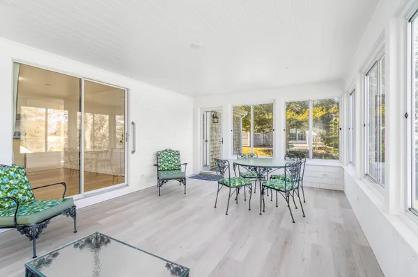 a dining room with furniture and wooden floor