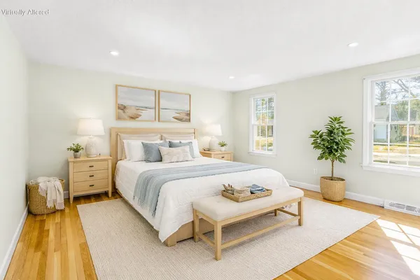 a bedroom with a bed and wooden floor