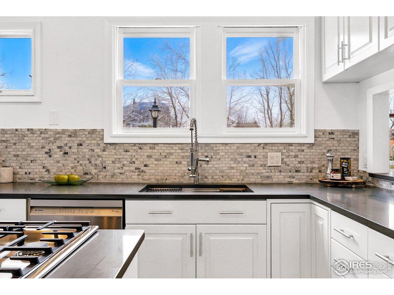 1741 Pine Street Boulder, CO 80302 - Photo 13 of 38 a kitchen with stainless steel appliances granite countertop a stove a sink and a microwave