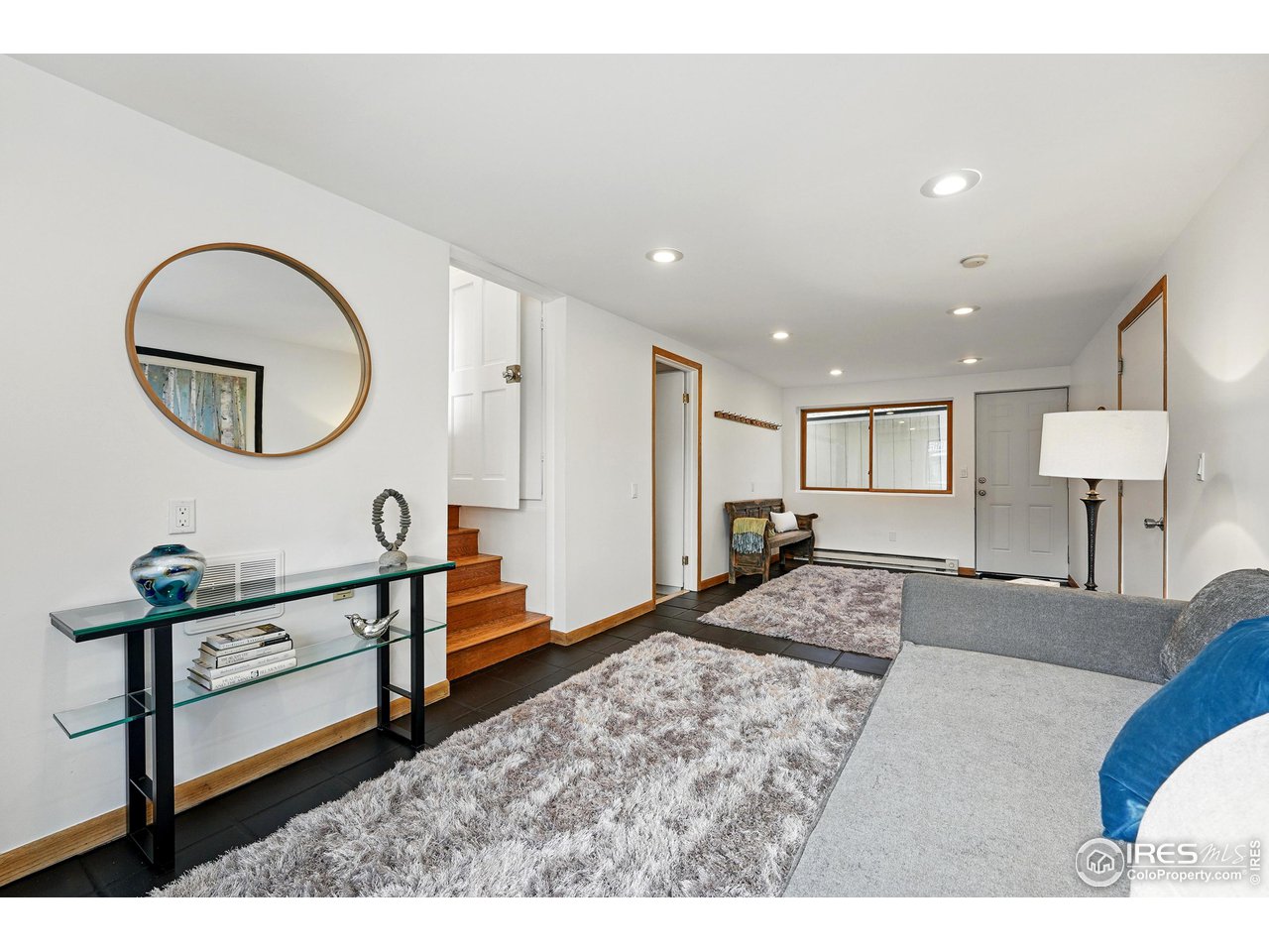 1741 Pine Street Boulder, CO 80302 - Photo 19 of 38 a spacious bedroom with a bed a mirror and a table