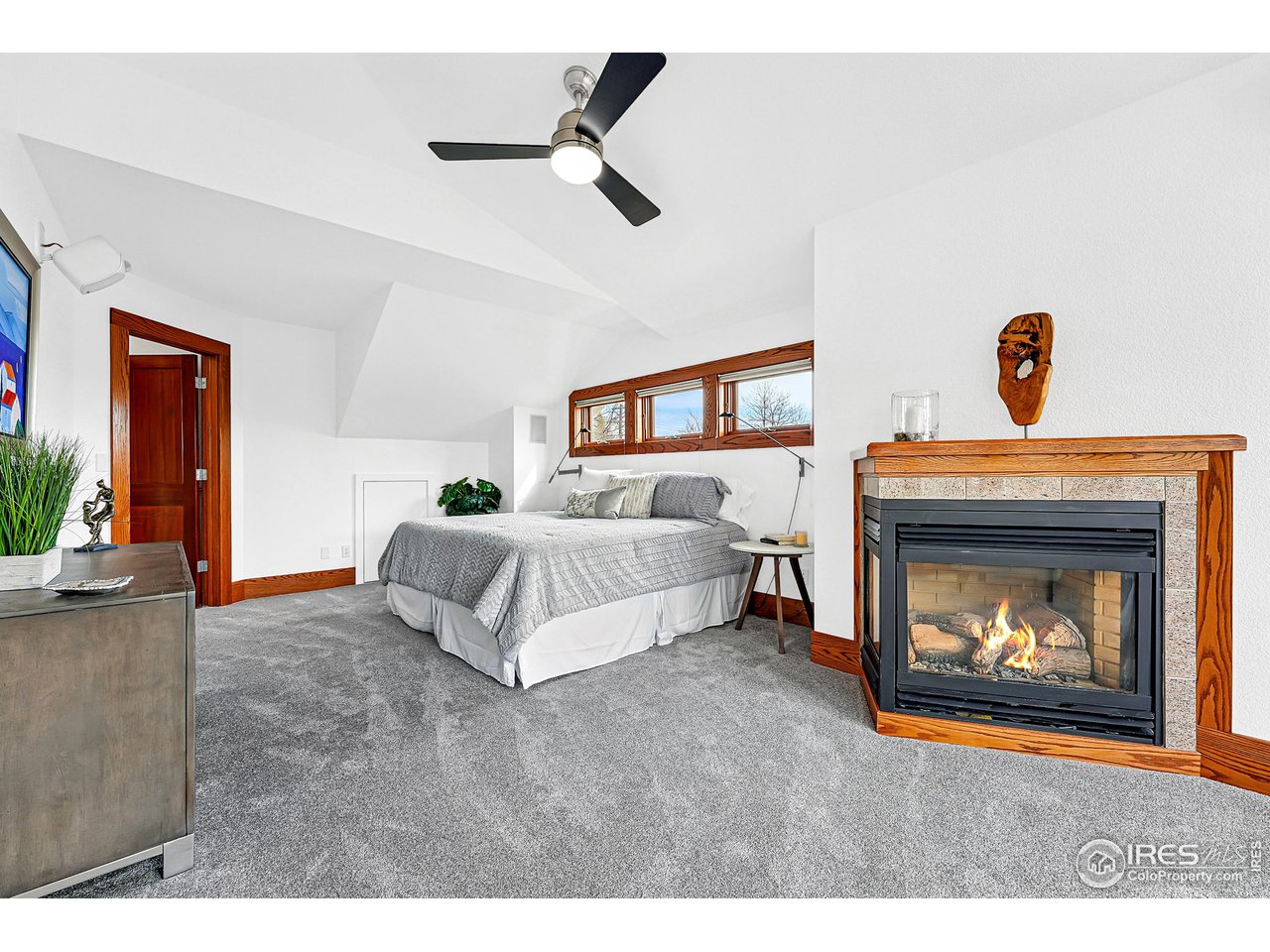 1741 Pine Street Boulder, CO 80302 - Photo 22 of 38 a spacious bedroom with a bed and a fireplace