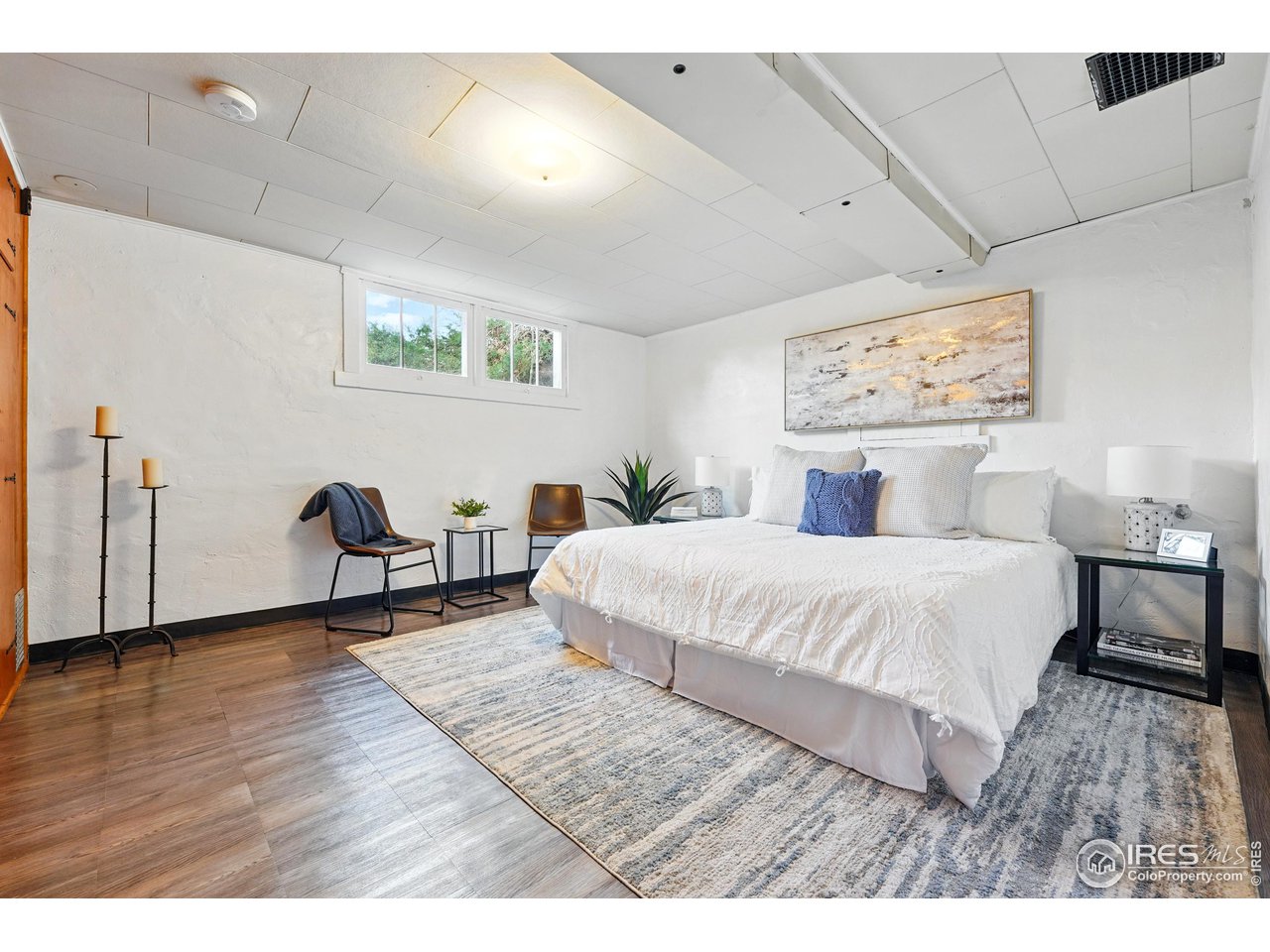 1741 Pine Street Boulder, CO 80302 - Photo 30 of 38 a bedroom with a bed and a painting on the wall