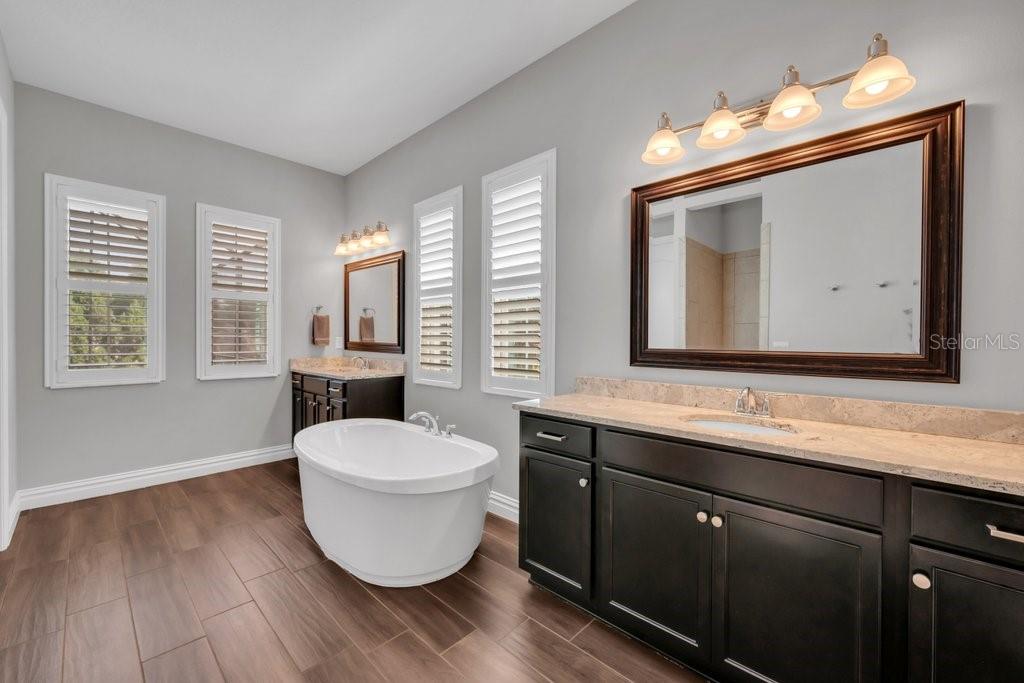 14908 Bassinger Lane Lithia, FL 33547 - Photo 24 of 56 a bathroom with a toilet sink and mirror