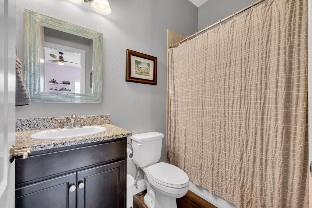 14908 Bassinger Lane Lithia, FL 33547 - Photo 32 of 56 a bathroom with a sink a toilet and mirror