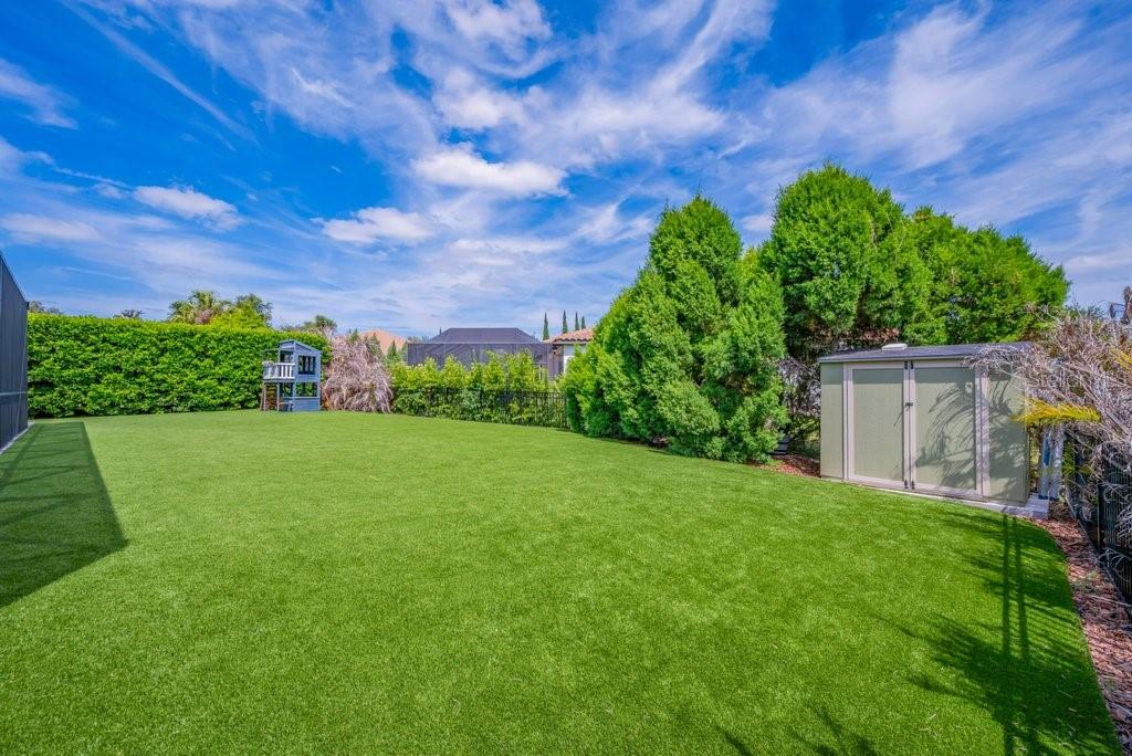 14908 Bassinger Lane Lithia, FL 33547 - Photo 5 of 56 a view of a garden with a building in the background