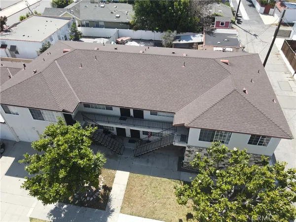 an aerial view of a house with a yard and potted plants