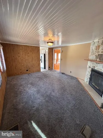 a view of empty room with window and fireplace