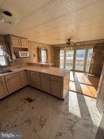 a large white kitchen with a large window