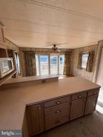 a room with a bed and large windows