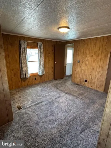 a view of a livingroom with wooden floor and a window
