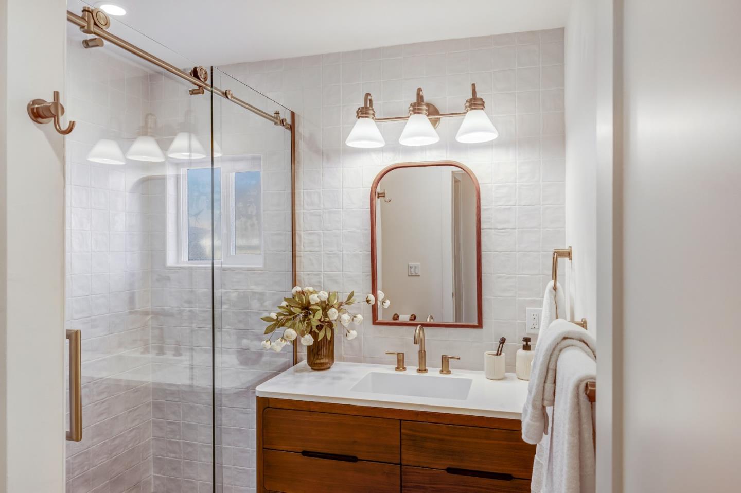 508 4th Street Pacific Grove, CA 93950 - Photo 12 of 20 a bathroom with a double vanity sink and a mirror