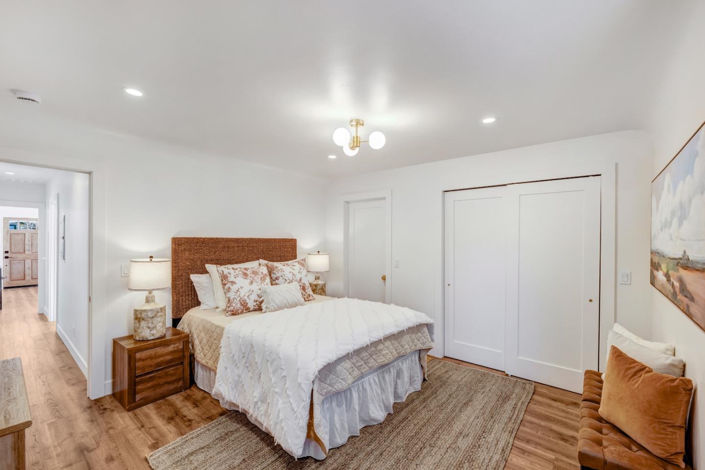 508 4th Street Pacific Grove, CA 93950 - Photo 13 of 20 a bedroom with a bed and a chandelier
