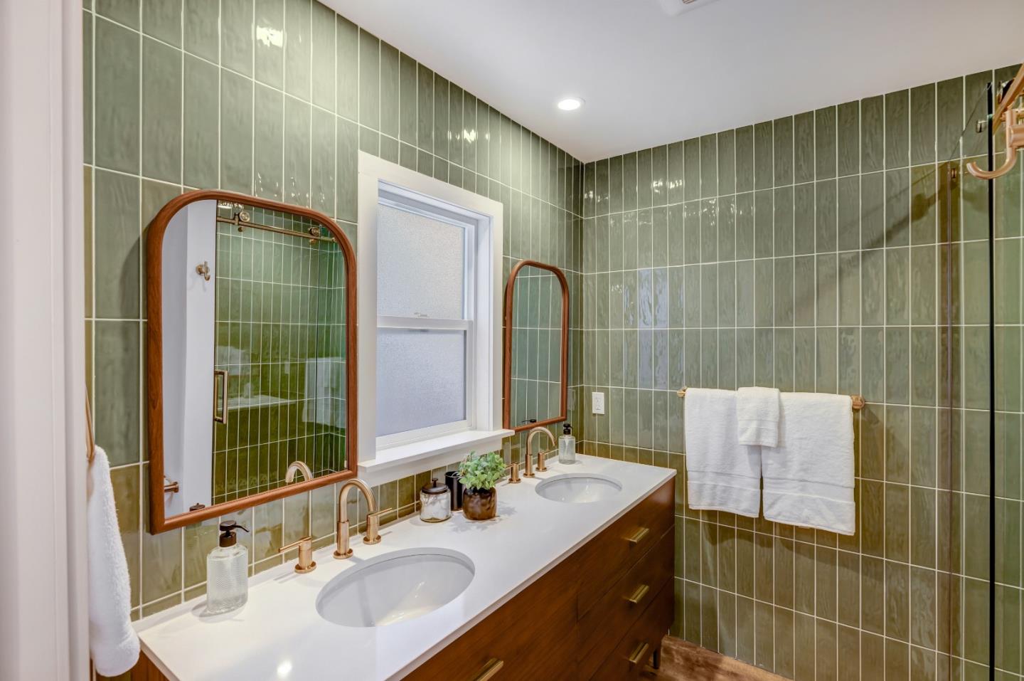 508 4th Street Pacific Grove, CA 93950 - Photo 15 of 20 a bathroom with a sink a shower and a mirror
