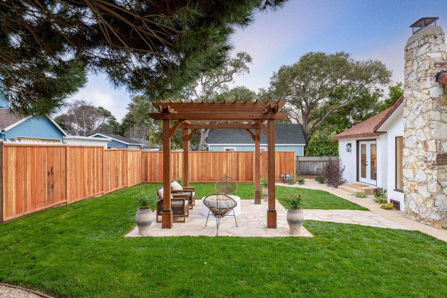 508 4th Street Pacific Grove, CA 93950 - Photo 18 of 20 a view of a chair and table in backyard of the house