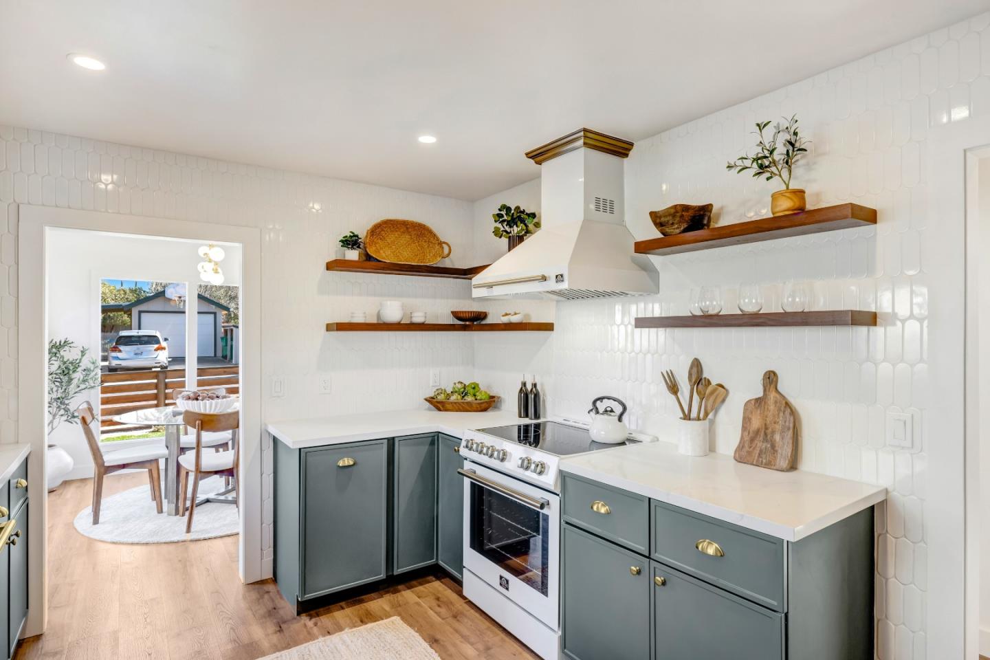 508 4th Street Pacific Grove, CA 93950 - Photo 8 of 20 a kitchen with stainless steel appliances granite countertop a sink a stove and wooden floor