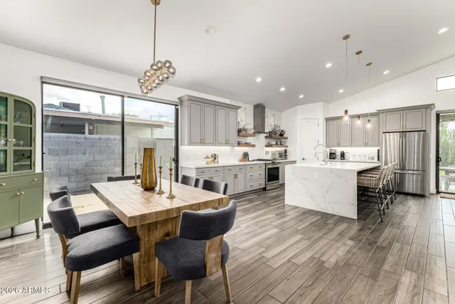 a large kitchen with a table and chairs