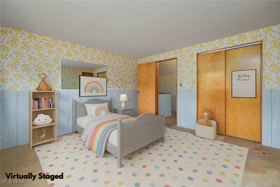 144 Substation Road Brunswick, OH 44212 - Photo 27 of 43 Bedroom with wallpapered walls, a wainscoted wall, and multiple closets