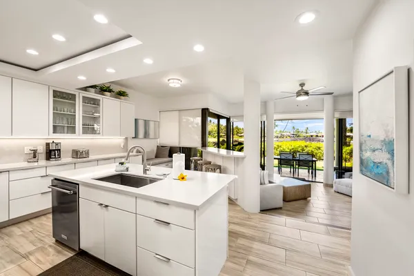 a kitchen with a sink cabinets and wooden floor